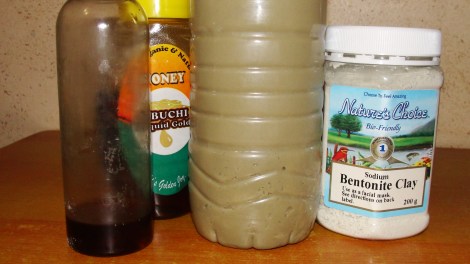 The ingredients used in my clay rinse with the pre-mixed bottle in the centre